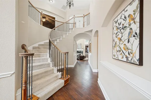 a view of entryway and hall with wooden floor