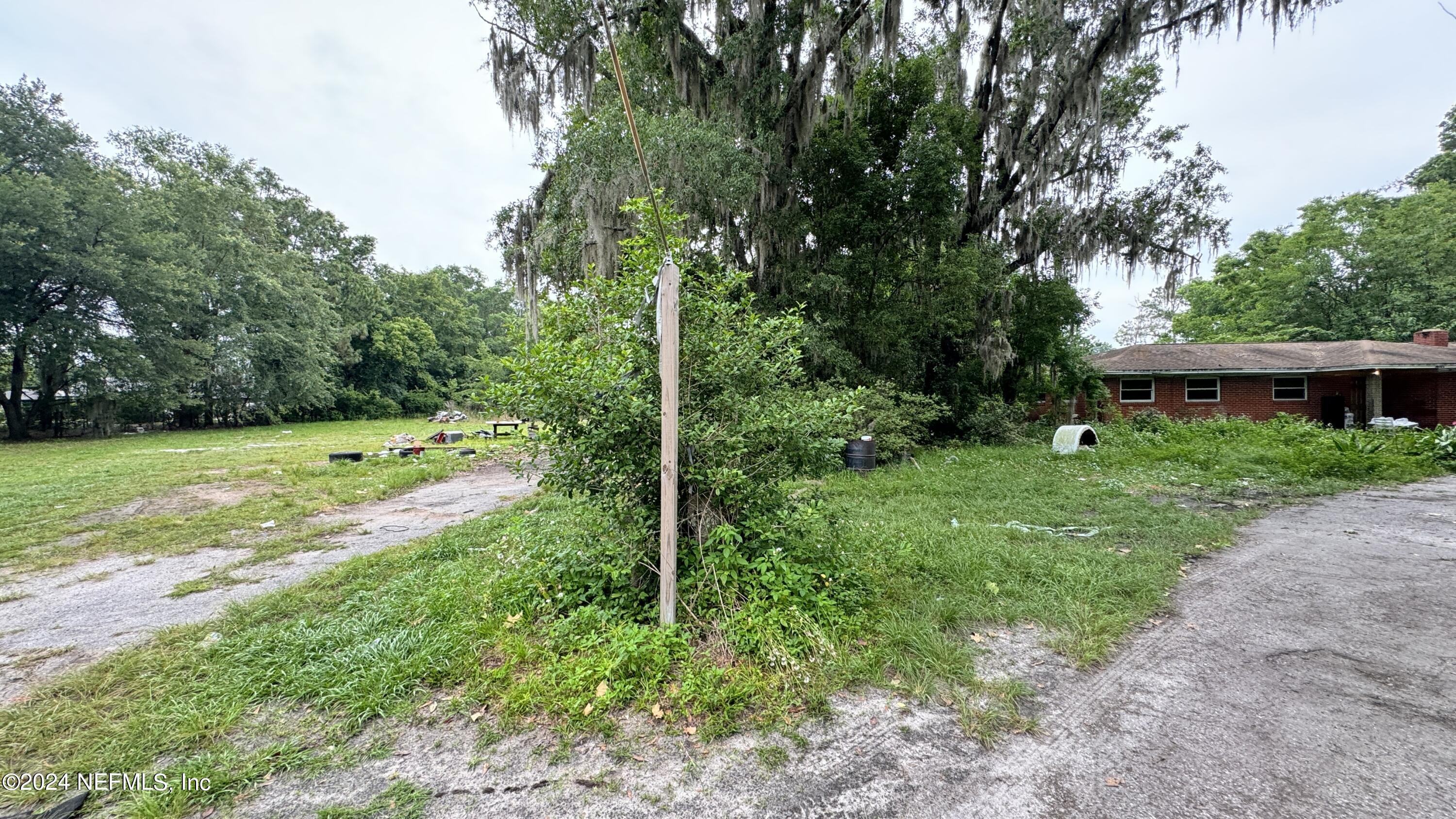 36107 Pine Street Hilliard, FL 32046 - Photo 16 of 27 a view of a house with a backyard