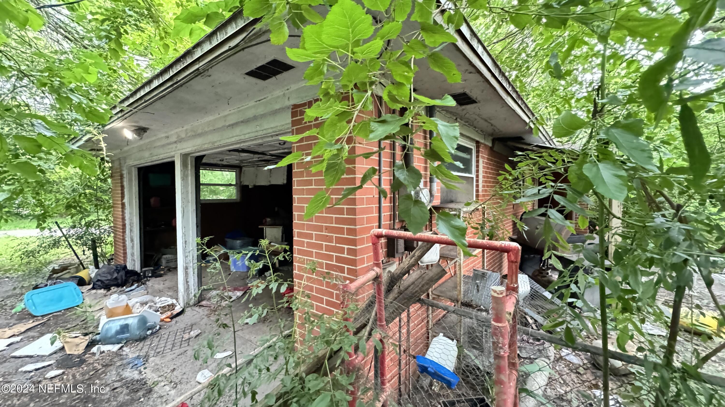 36107 Pine Street Hilliard, FL 32046 - Photo 19 of 27 a backyard of a house with outdoor seating