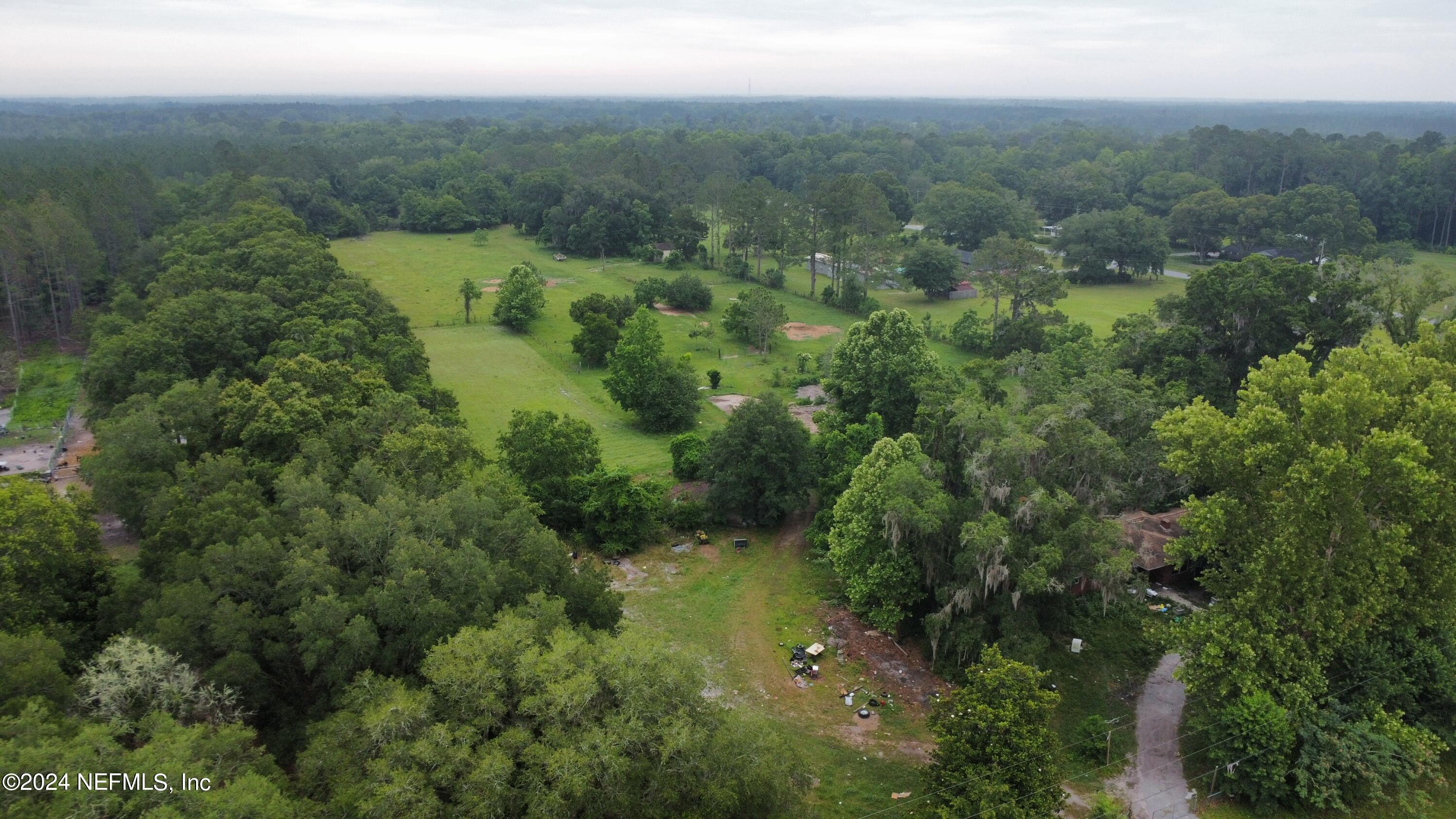36107 Pine Street Hilliard, FL 32046 - Photo 2 of 27 a view of a forest with a street