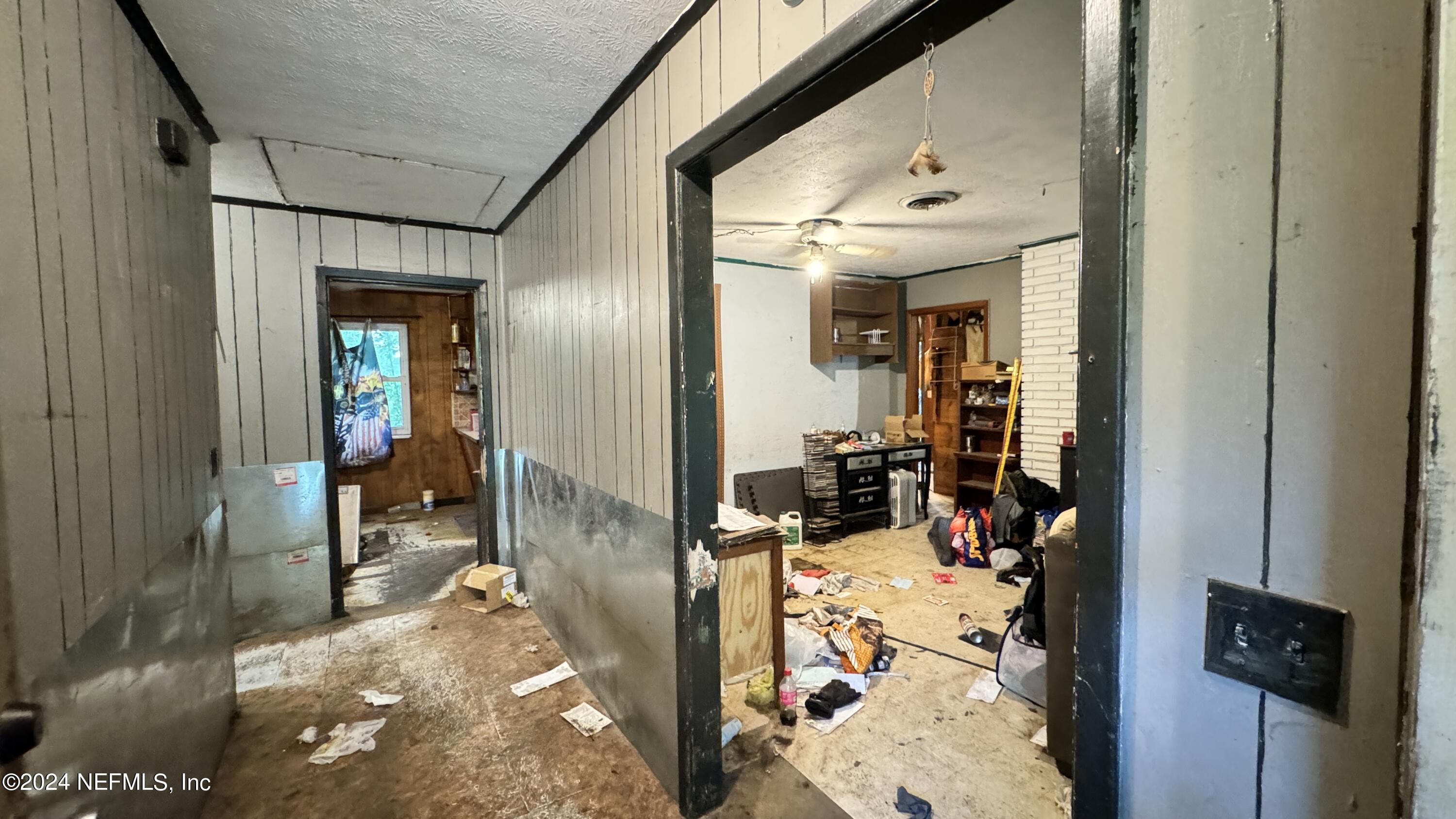 36107 Pine Street Hilliard, FL 32046 - Photo 21 of 27 a view of a hallway with a livingroom and a bathroom with mirror