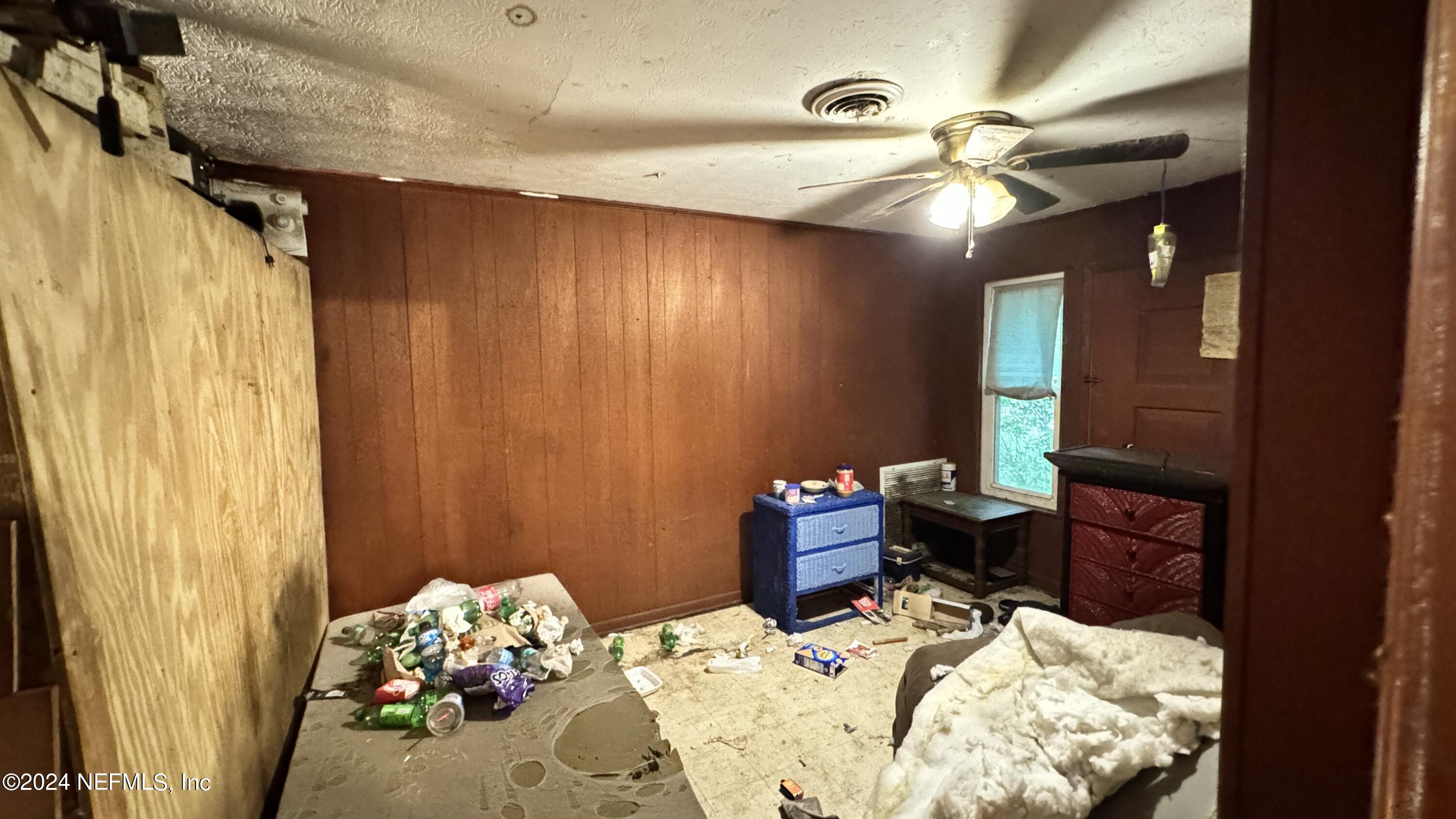 36107 Pine Street Hilliard, FL 32046 - Photo 23 of 27 a bed room with a bed mirror and a window