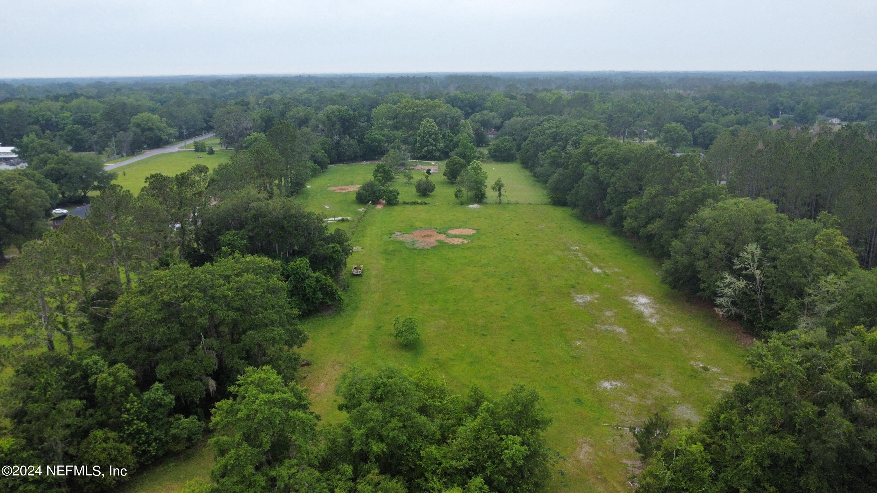 36107 Pine Street Hilliard, FL 32046 - Photo 5 of 27 an aerial view of residential houses with outdoor space and trees