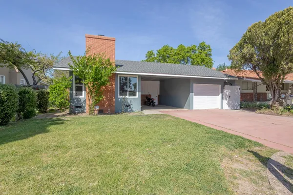 a front view of house with yard and trees