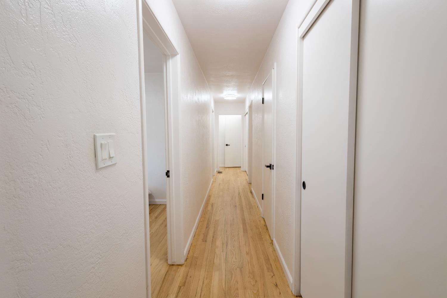 39 West Fulton Street Stockton, CA 95204 - Photo 14 of 31 a view of a hallway with wooden floor and a bathroom