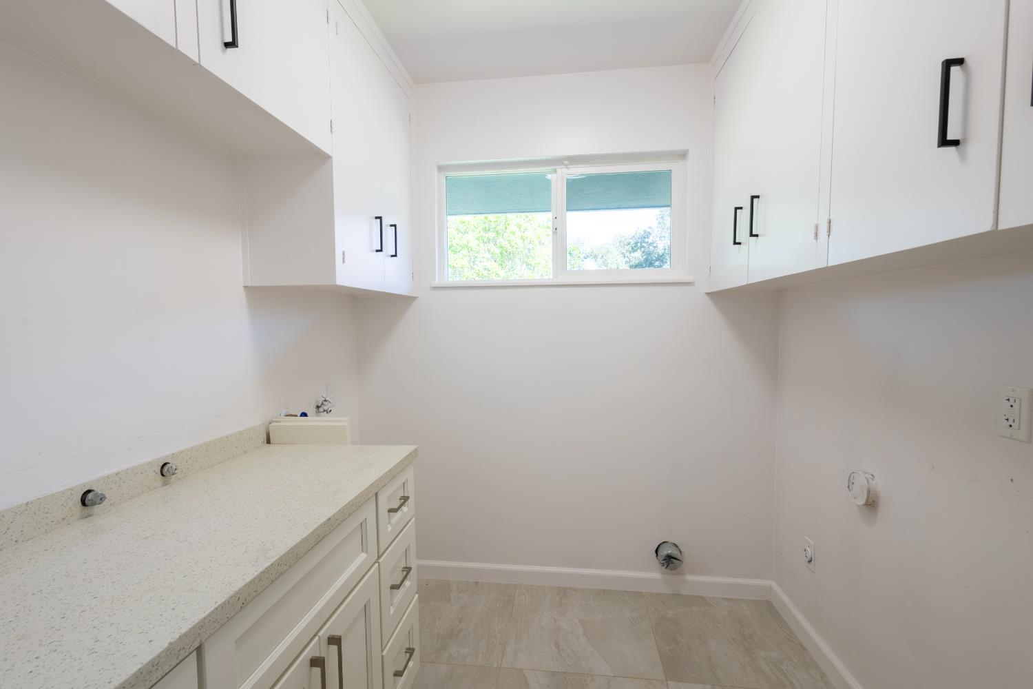 39 West Fulton Street Stockton, CA 95204 - Photo 16 of 31 a view of a kitchen with white cabinets and a sink