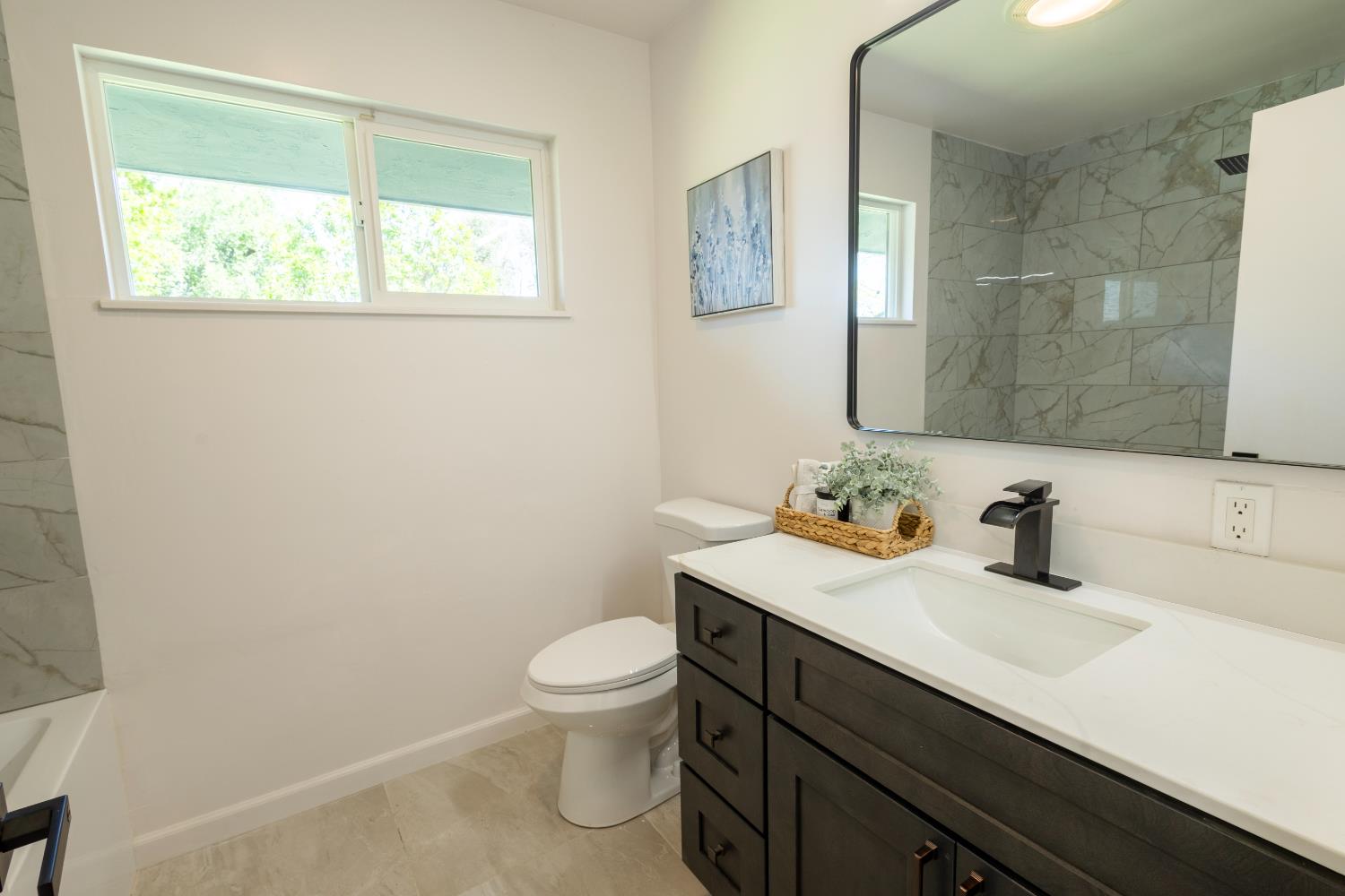 39 West Fulton Street Stockton, CA 95204 - Photo 17 of 31 a bathroom with a sink a toilet and a mirror