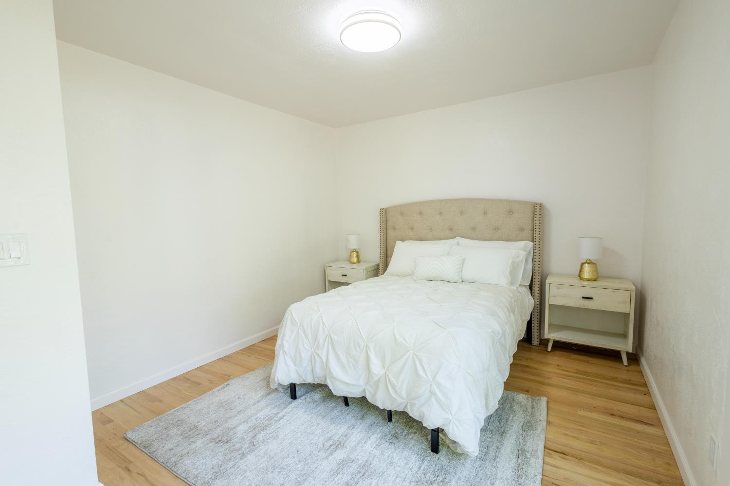 39 West Fulton Street Stockton, CA 95204 - Photo 21 of 31 a bedroom with a bed and wooden floor