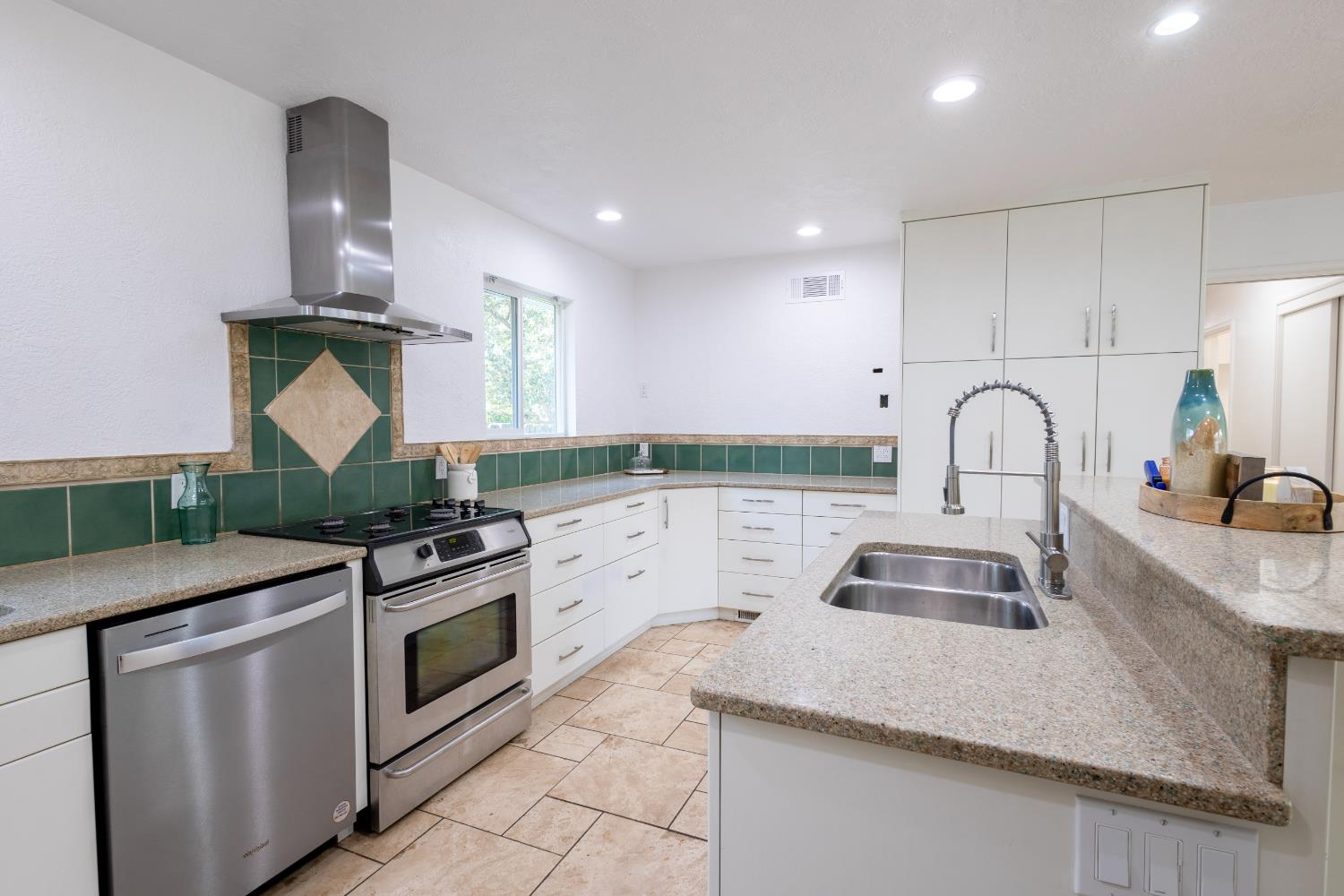 39 West Fulton Street Stockton, CA 95204 - Photo 7 of 31 a kitchen with granite countertop a sink stainless steel appliances and cabinets
