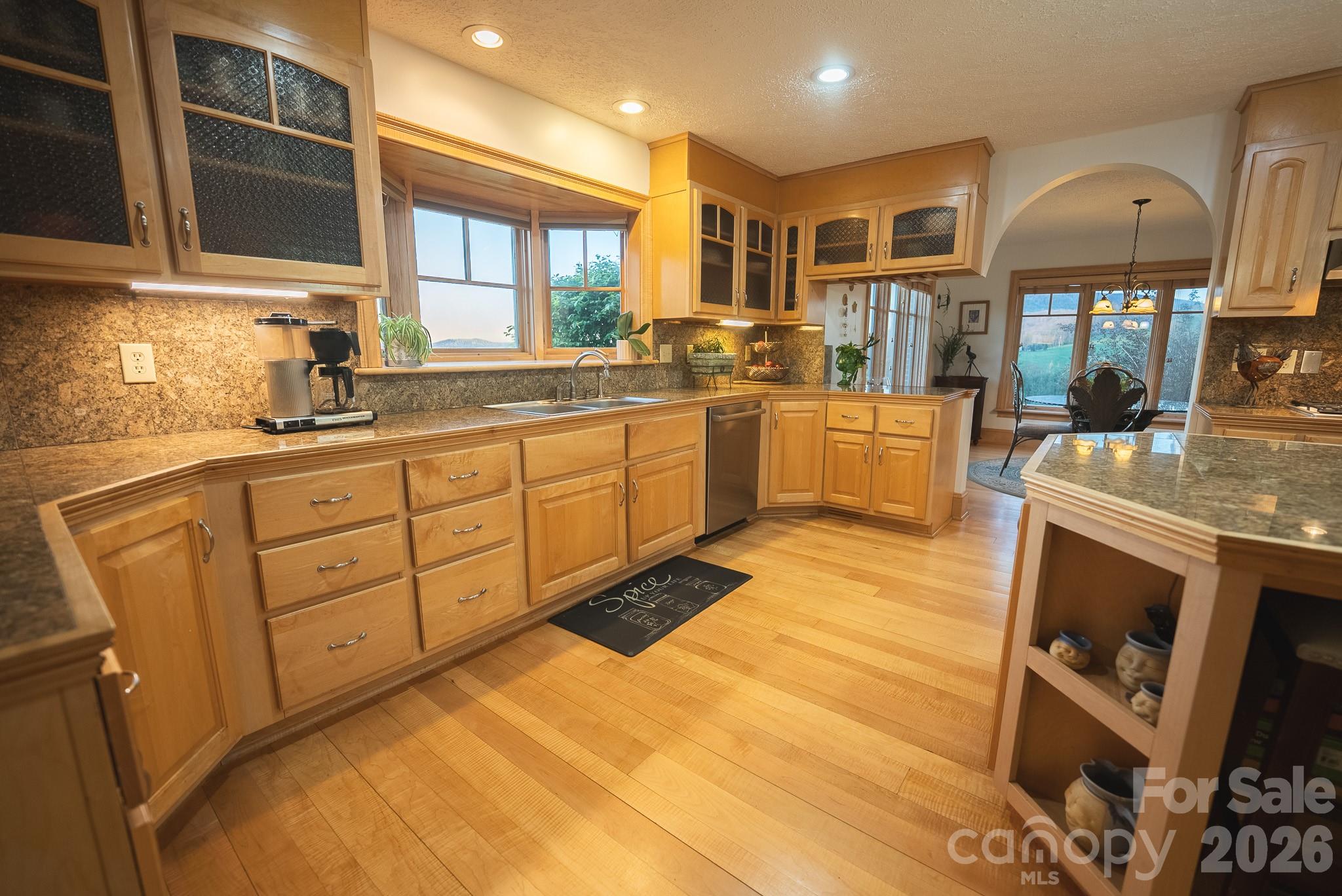 6985 Junaluska Road Boone, NC 28607 - Photo 29 of 35 a kitchen with stainless steel appliances granite countertop a sink and cabinets