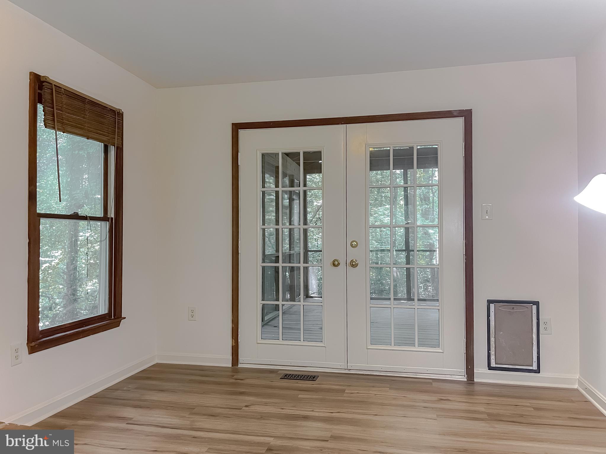 960 Bowie Shop Road Huntingtown, MD 20639 - Photo 23 of 69 a view of an empty room with wooden floor and windows