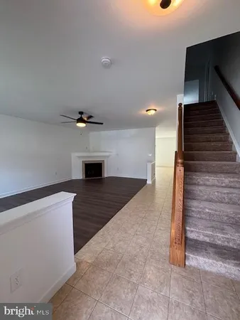 a view of an empty room and wooden floor