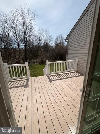 a view of balcony with wooden floor and fence