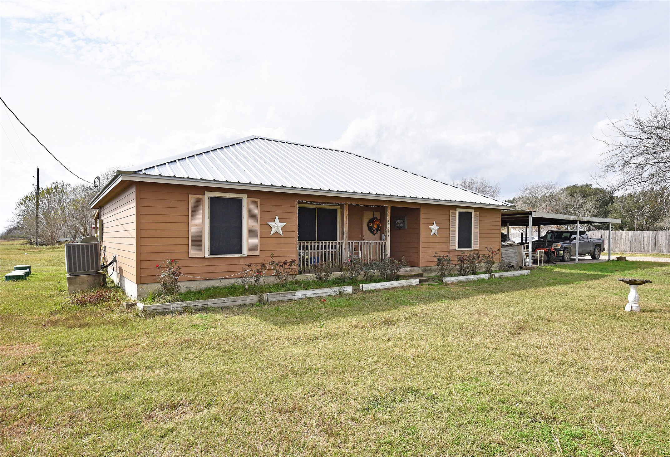 6018 FM 360 Road Needville, TX 77461 - Photo 14 of 50 a front view of house with a garden and patio