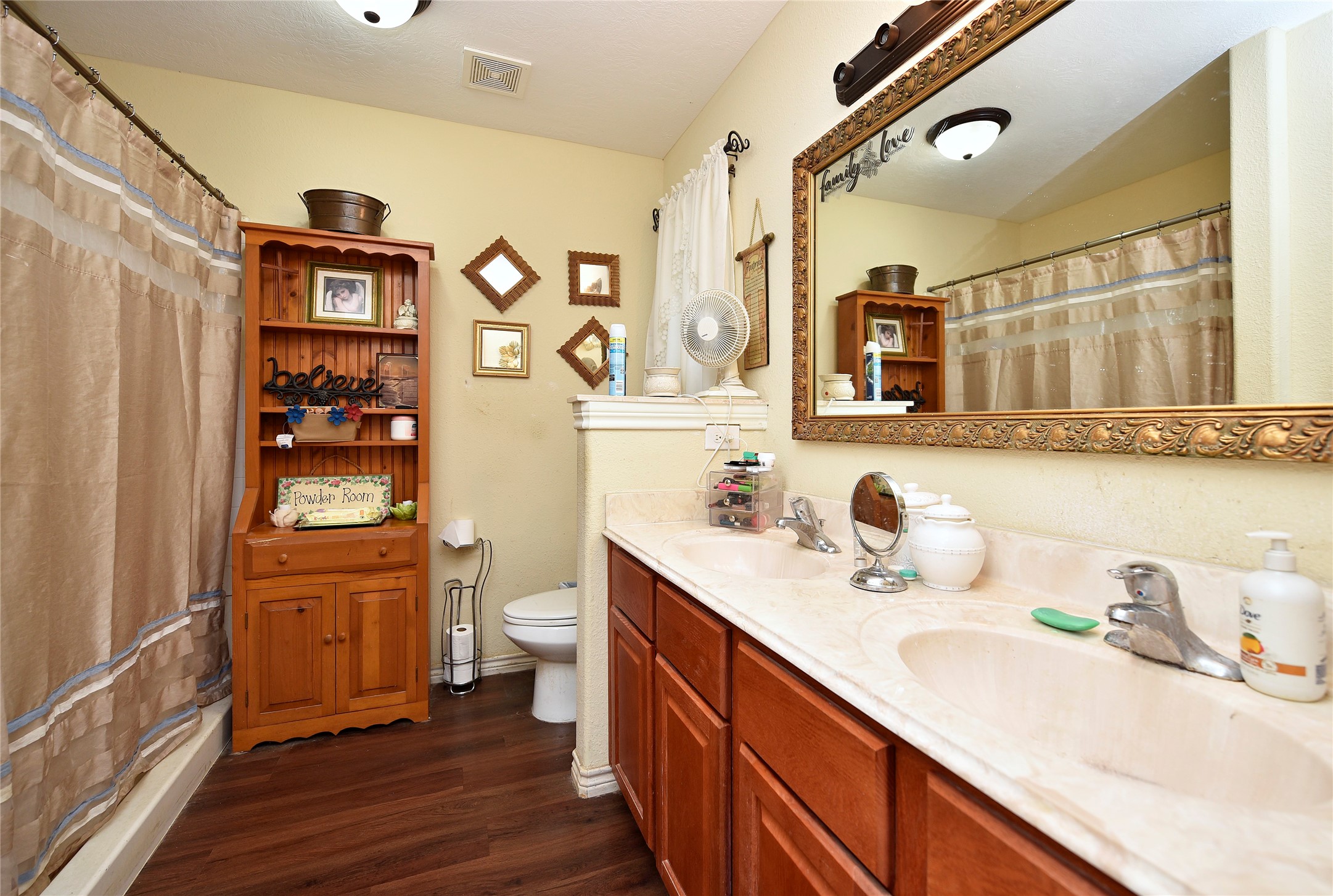 6018 FM 360 Road Needville, TX 77461 - Photo 25 of 50 a bathroom with a sink a toilet and shower curtain