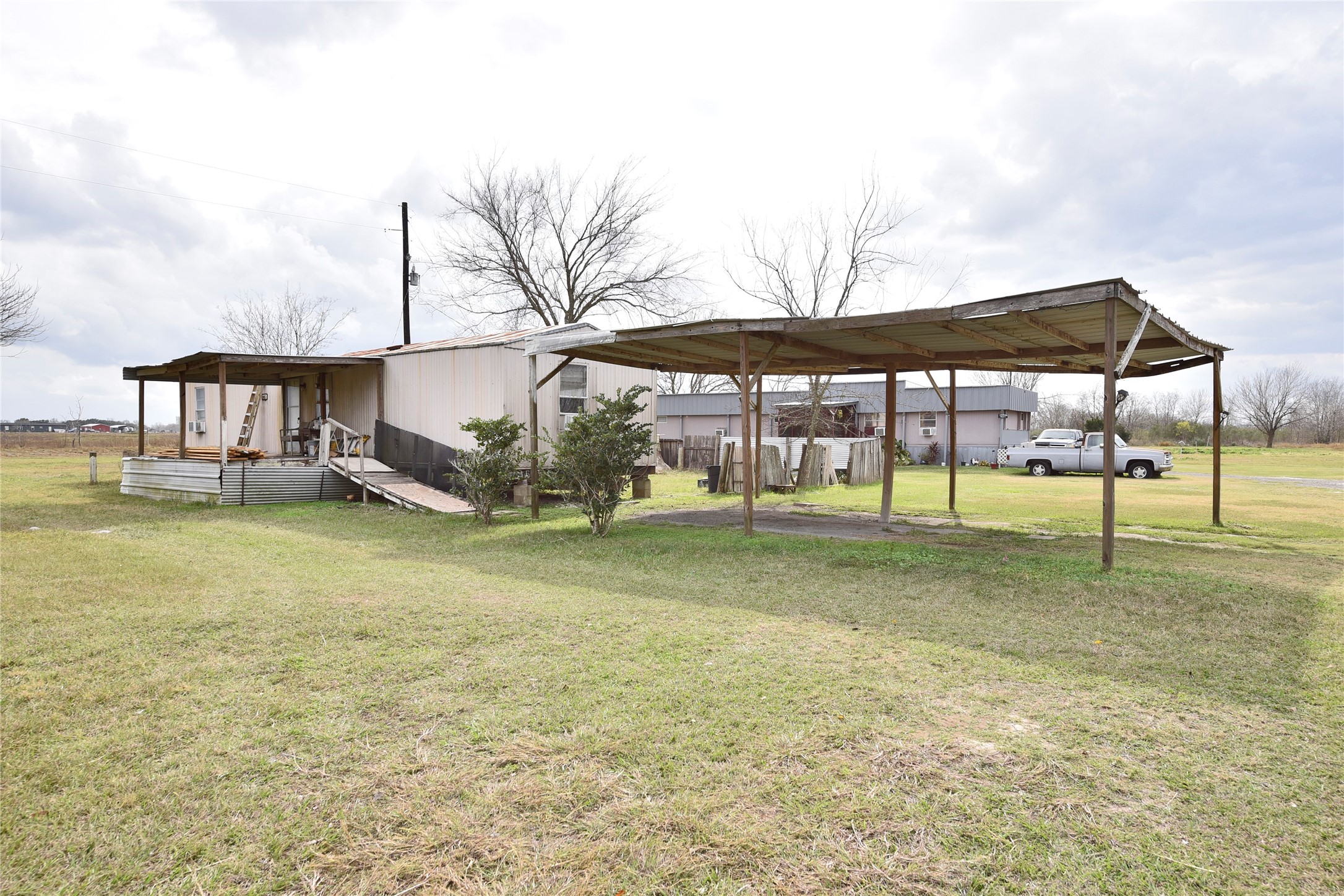 6018 FM 360 Road Needville, TX 77461 - Photo 36 of 50 a backyard of a house with barbeque oven table and chairs