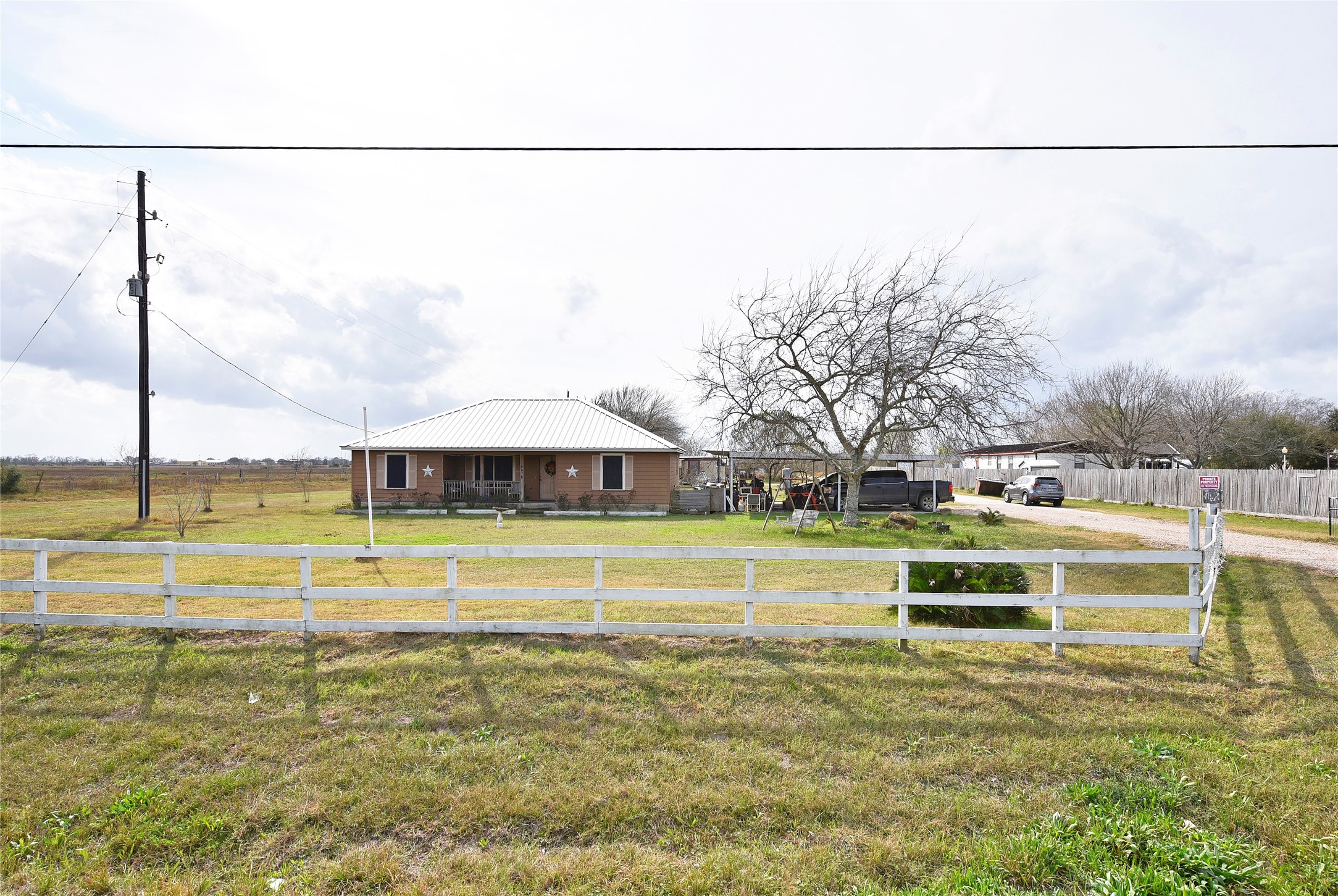 6018 FM 360 Road Needville, TX 77461 - Photo 9 of 50 a view of a swimming pool with a lawn chairs under an umbrella
