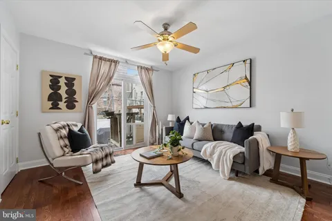 a living room with furniture a table and a large window