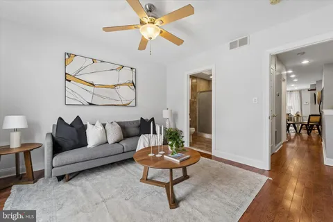 a living room with furniture a rug and a chandelier