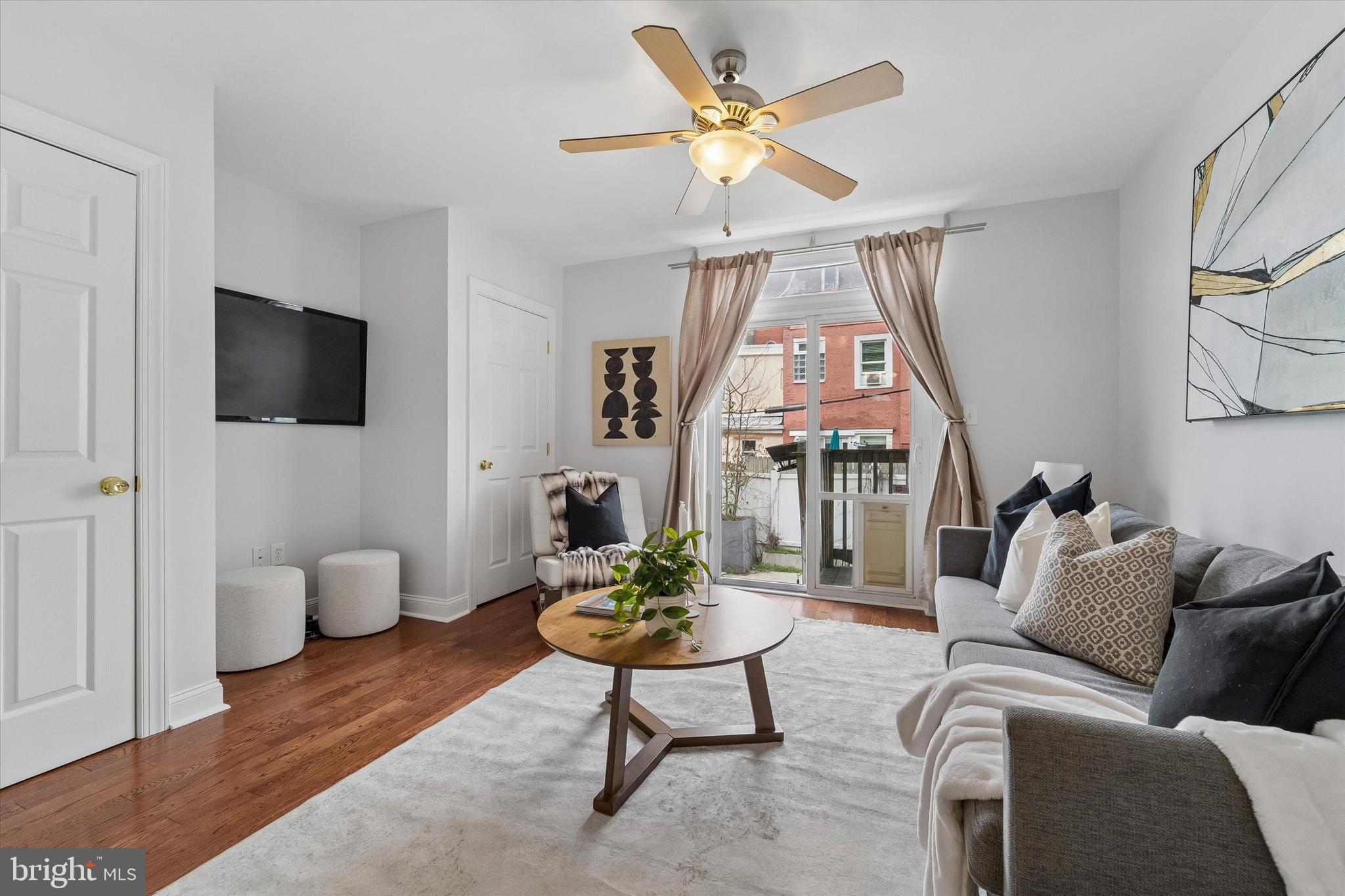 2001 Carpenter Street, Unit B Philadelphia, PA 19146 - Photo 14 of 31 a living room with furniture a flat screen tv and a window