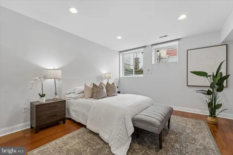 a bedroom with a bed and a potted plant