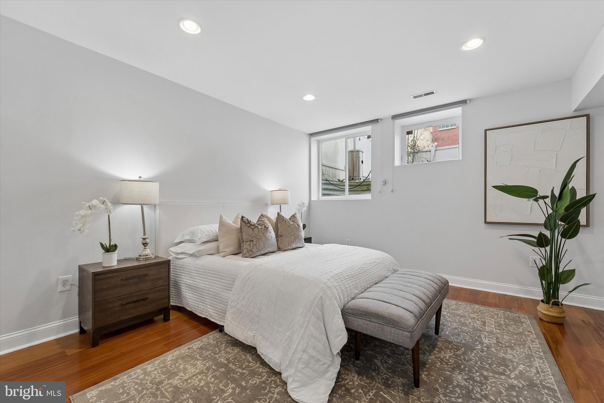2001 Carpenter Street, Unit B Philadelphia, PA 19146 - Photo 16 of 31 a bedroom with a bed and a potted plant