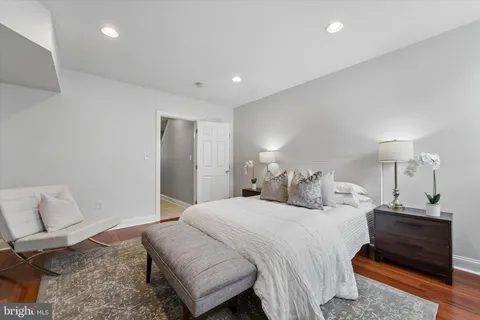 a bedroom with a bed and a lamp