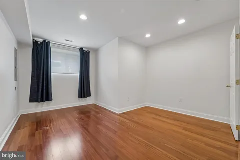 a view of a room with wooden floor