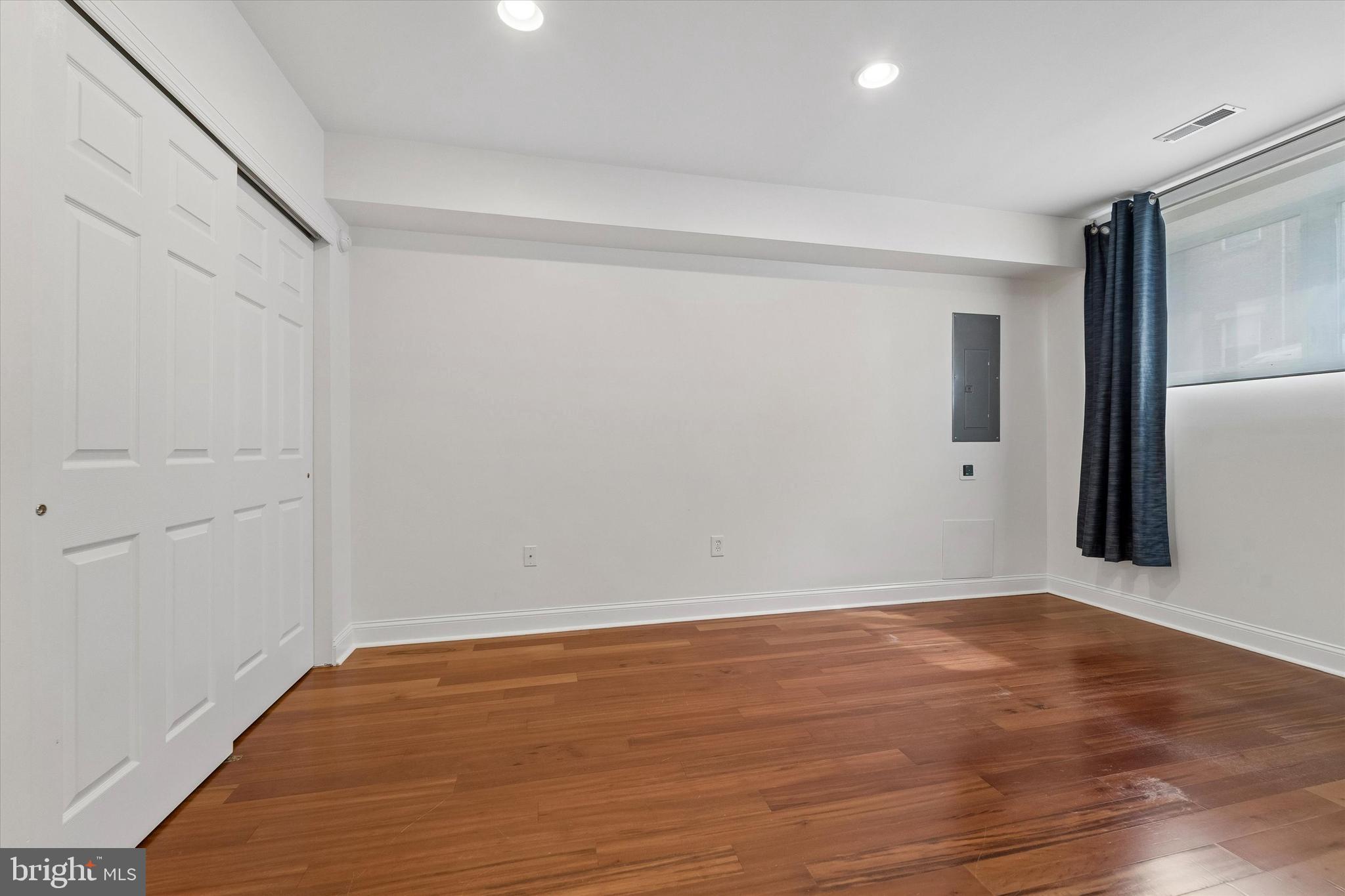 2001 Carpenter Street, Unit B Philadelphia, PA 19146 - Photo 20 of 31 a view of an empty room with wooden floor and a window