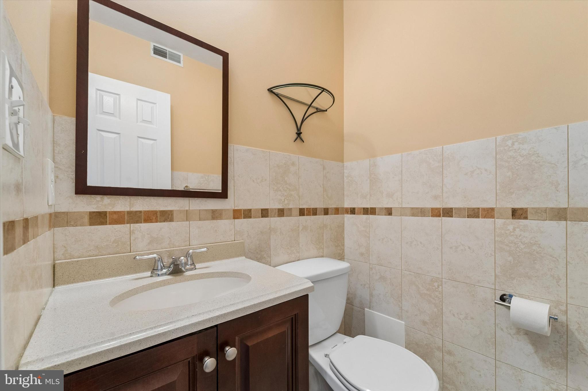 2001 Carpenter Street, Unit B Philadelphia, PA 19146 - Photo 22 of 31 a bathroom with a sink vanity mirror and toilet