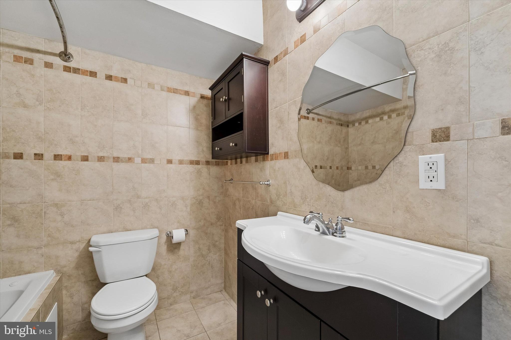 2001 Carpenter Street, Unit B Philadelphia, PA 19146 - Photo 23 of 31 a bathroom with a sink a toilet and a mirror