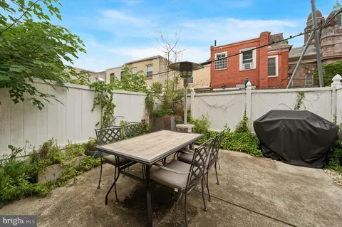 a view of a patio with table and chairs and potted plants