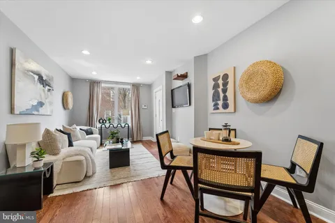 a living room with furniture and wooden floor