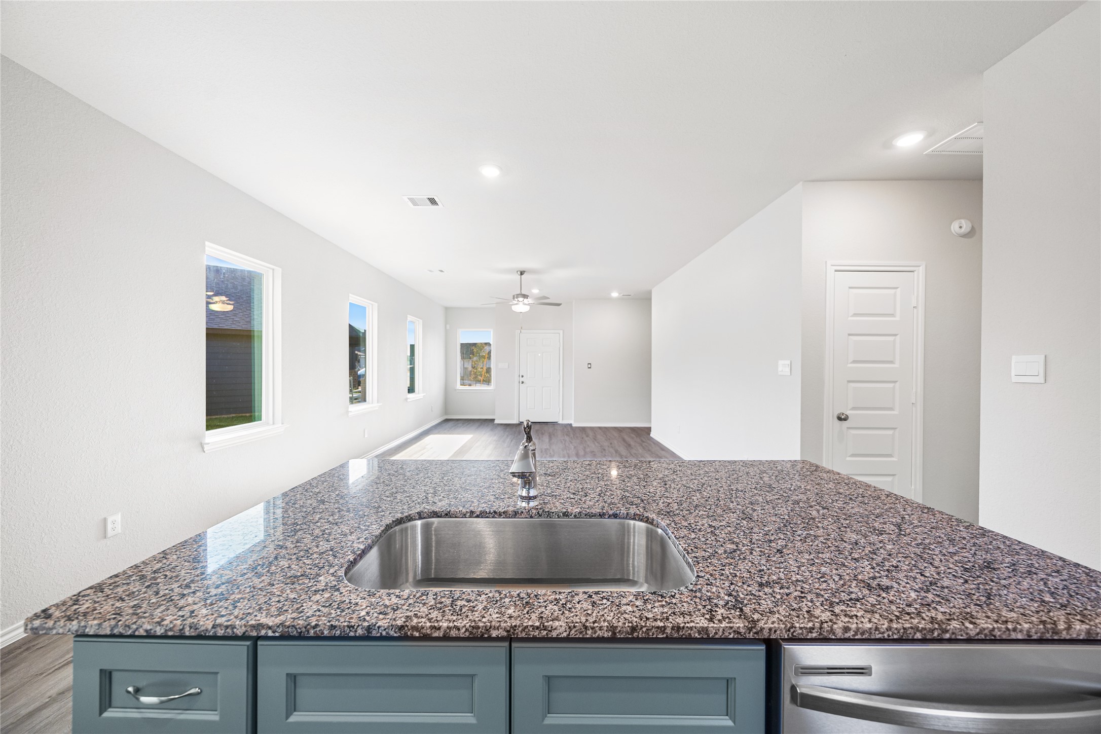 25799 John Wayne Court Splendora, TX 77372 - Photo 13 of 28 a kitchen with a sink and granite counter tops