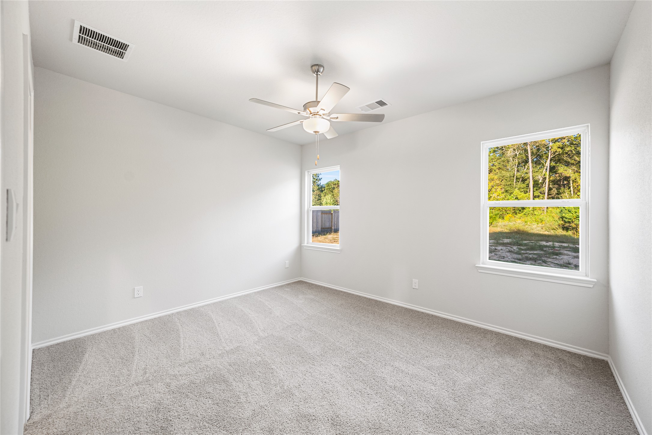 25799 John Wayne Court Splendora, TX 77372 - Photo 14 of 28 an empty room with windows and fan