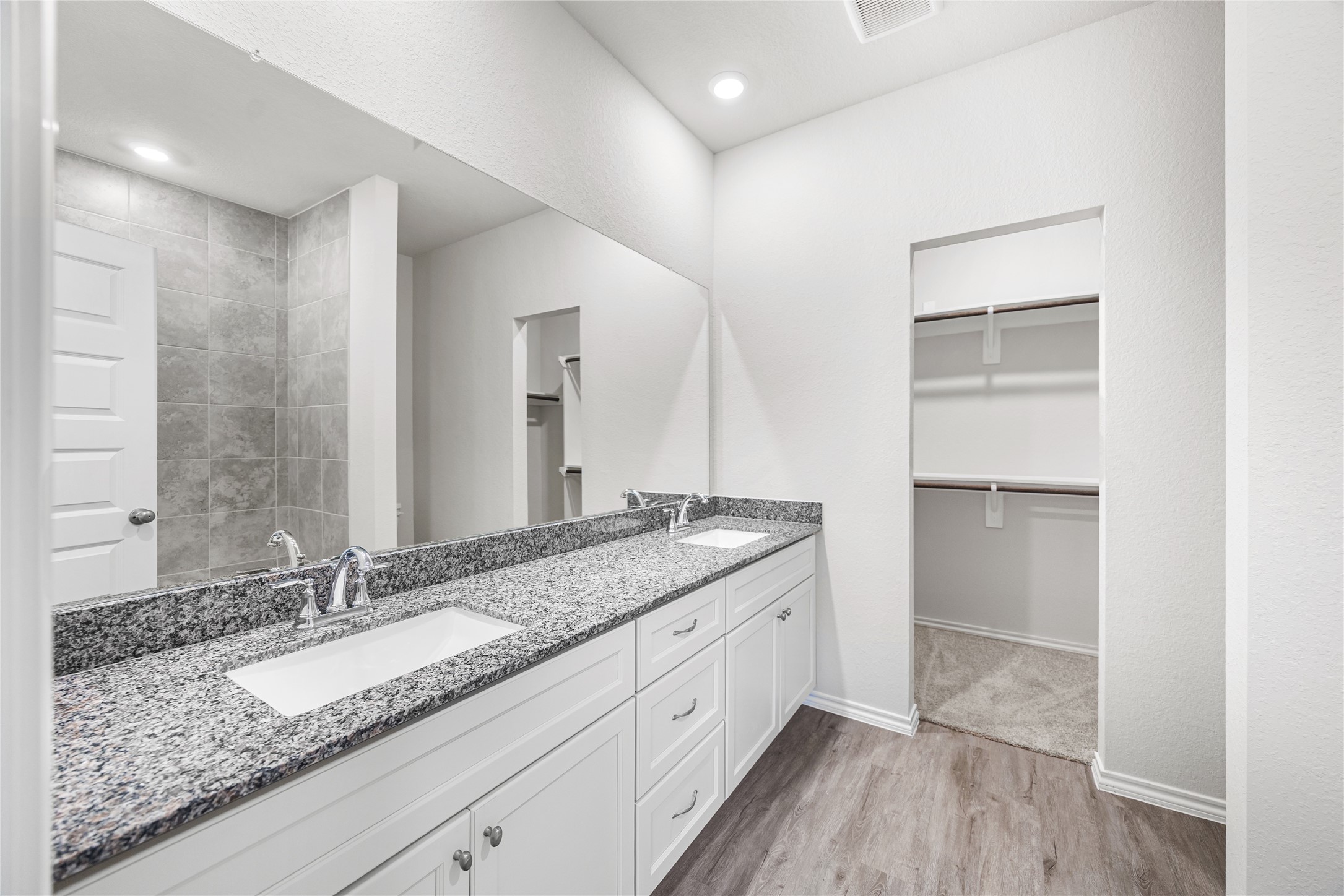 25799 John Wayne Court Splendora, TX 77372 - Photo 17 of 28 a bathroom with a granite countertop sink and a mirror