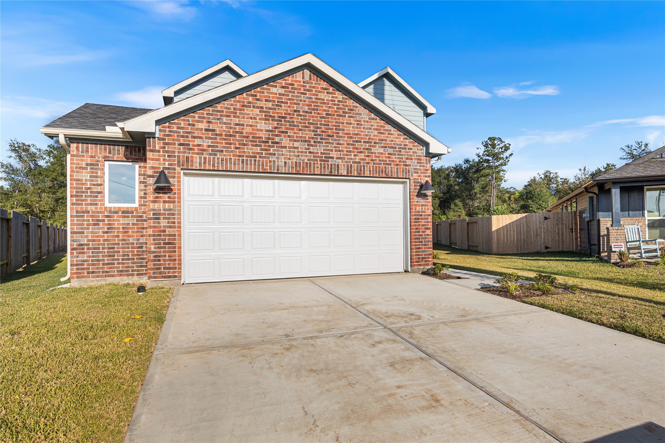 25799 John Wayne Court Splendora, TX 77372 - Photo 2 of 28 a view of a house with a backyard and a garage