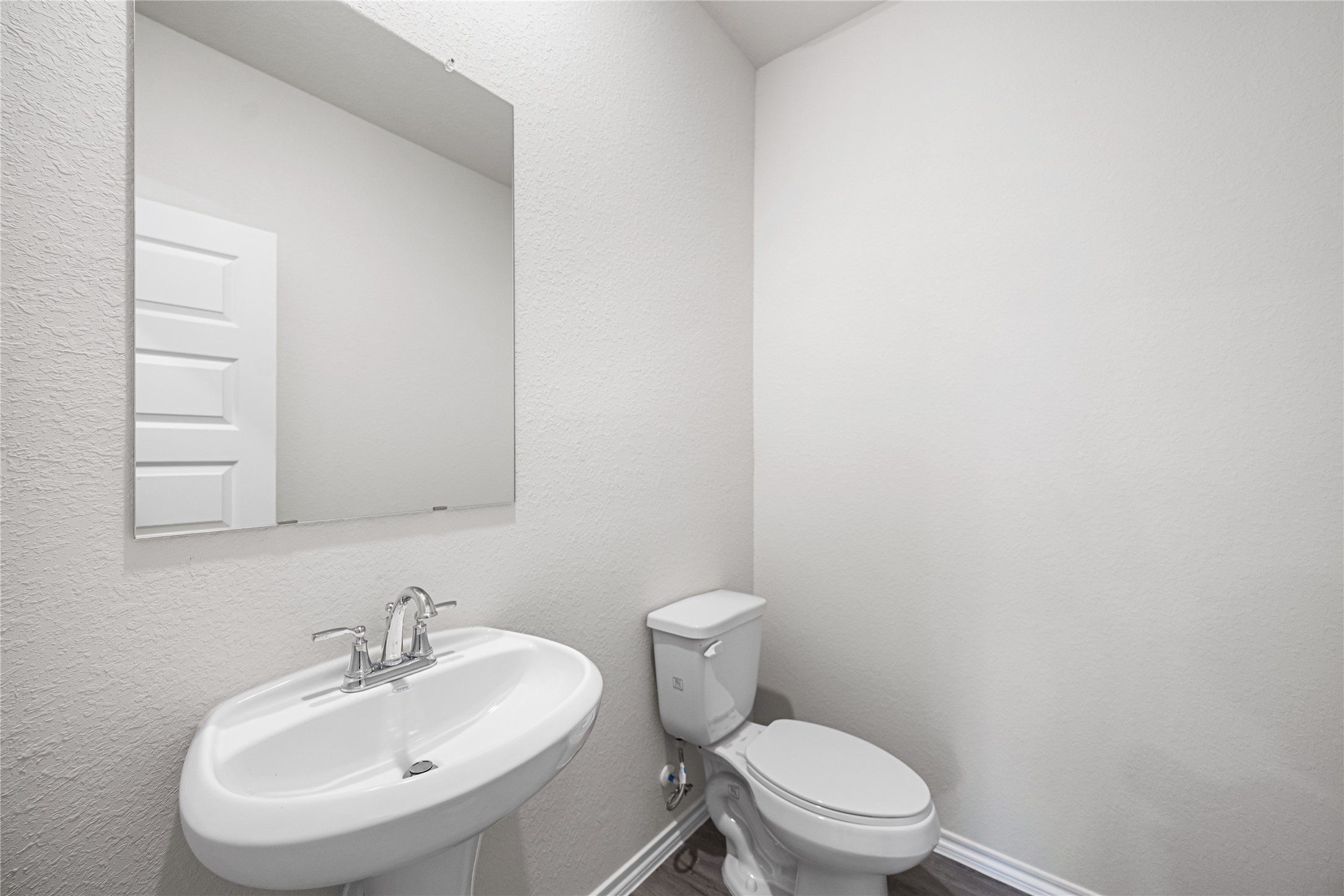 25799 John Wayne Court Splendora, TX 77372 - Photo 21 of 28 a bathroom with a sink a toilet and mirror