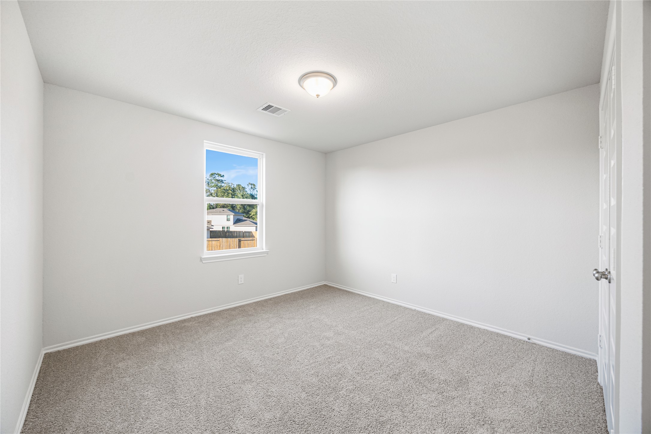 25799 John Wayne Court Splendora, TX 77372 - Photo 23 of 28 an empty room with a window