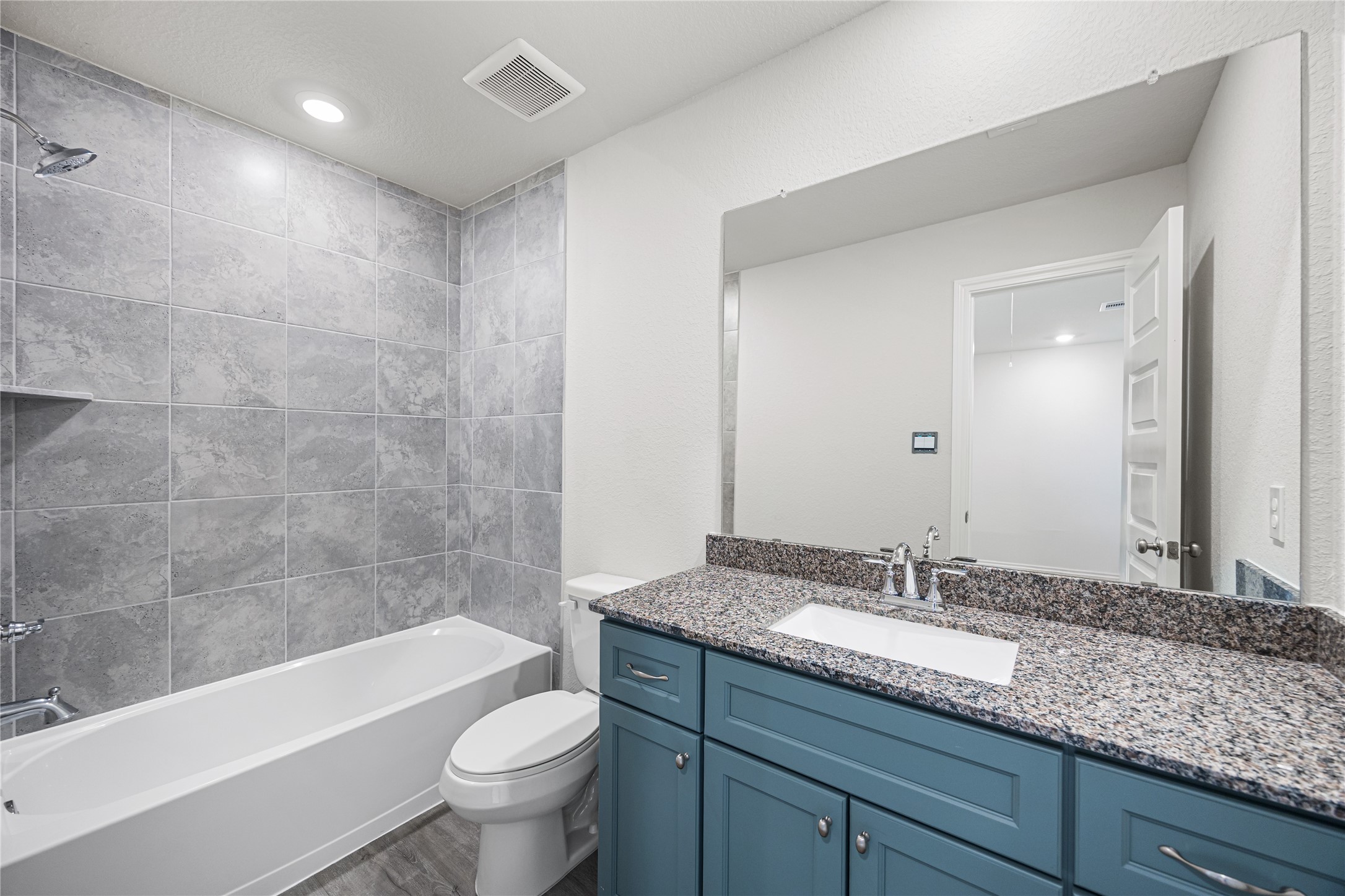 25799 John Wayne Court Splendora, TX 77372 - Photo 24 of 28 a bathroom with a granite countertop sink a toilet and bathtub