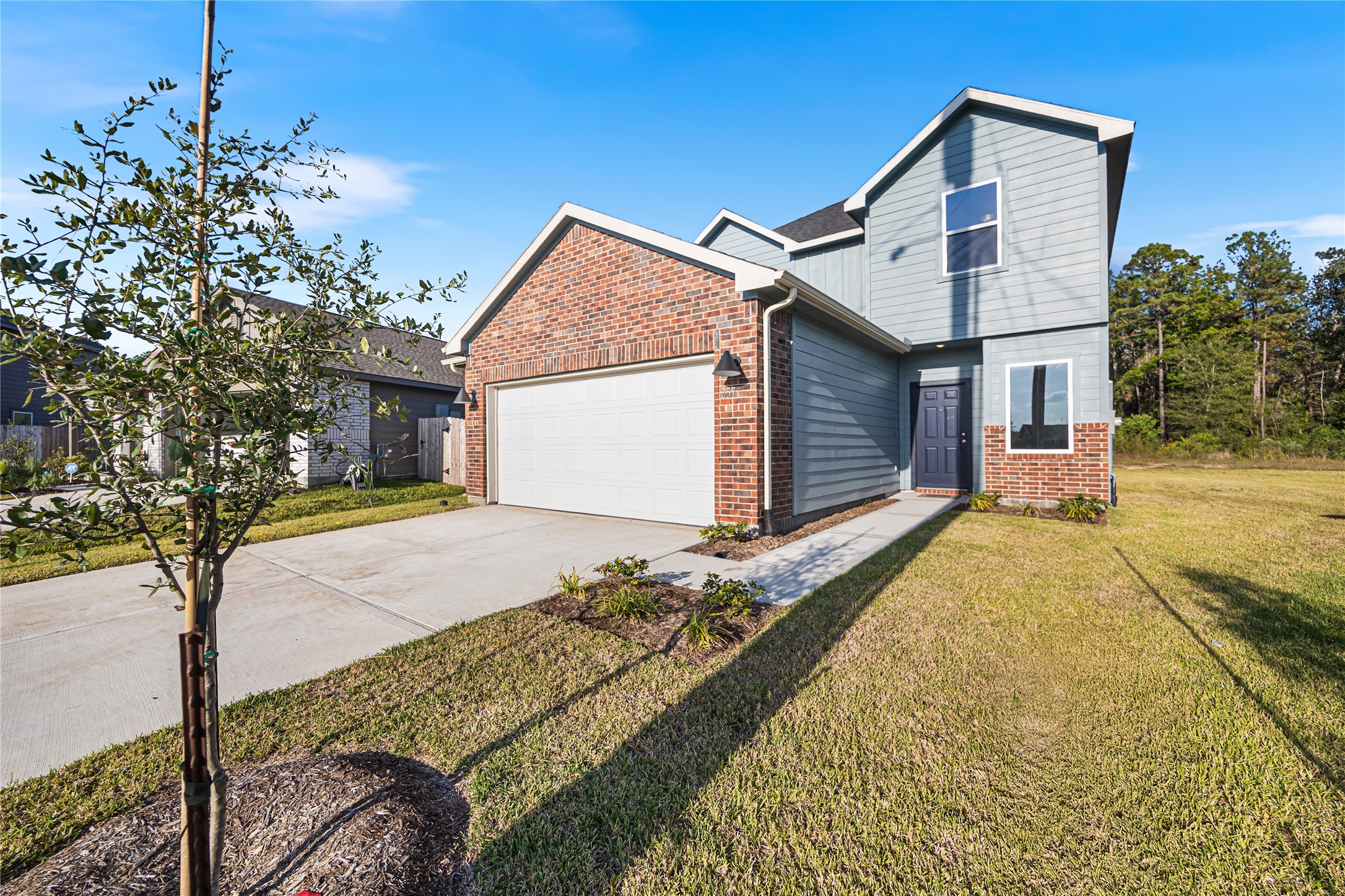 25799 John Wayne Court Splendora, TX 77372 - Photo 3 of 28 a front view of a house with a yard