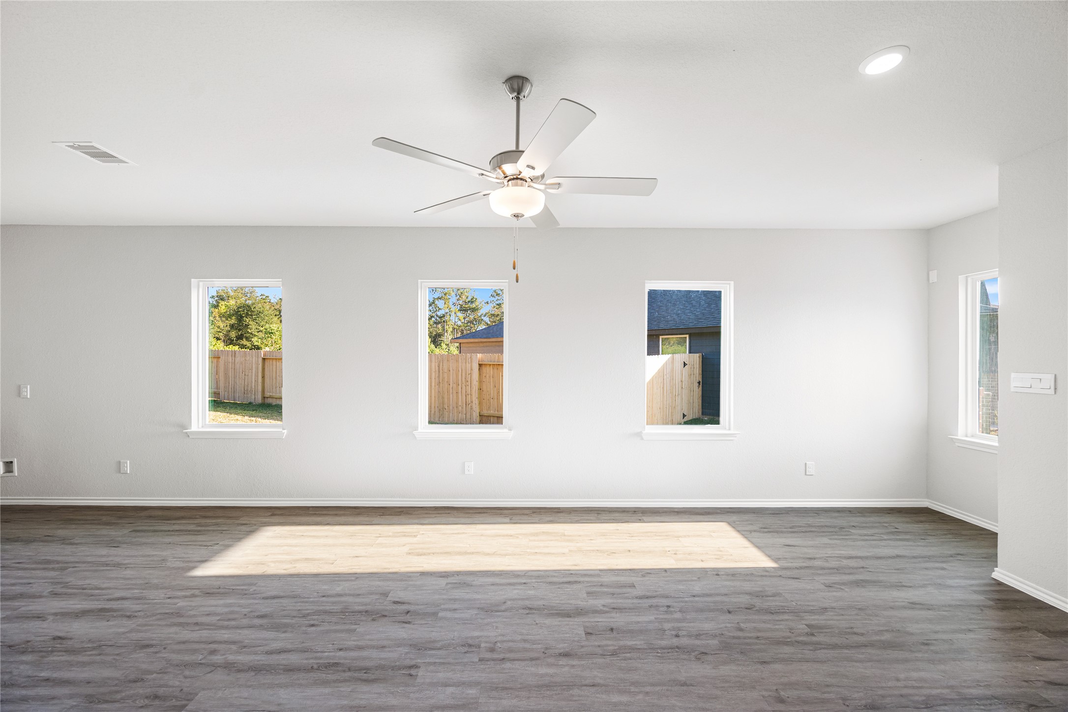 25799 John Wayne Court Splendora, TX 77372 - Photo 6 of 28 a view of an empty room with wooden floor and a window