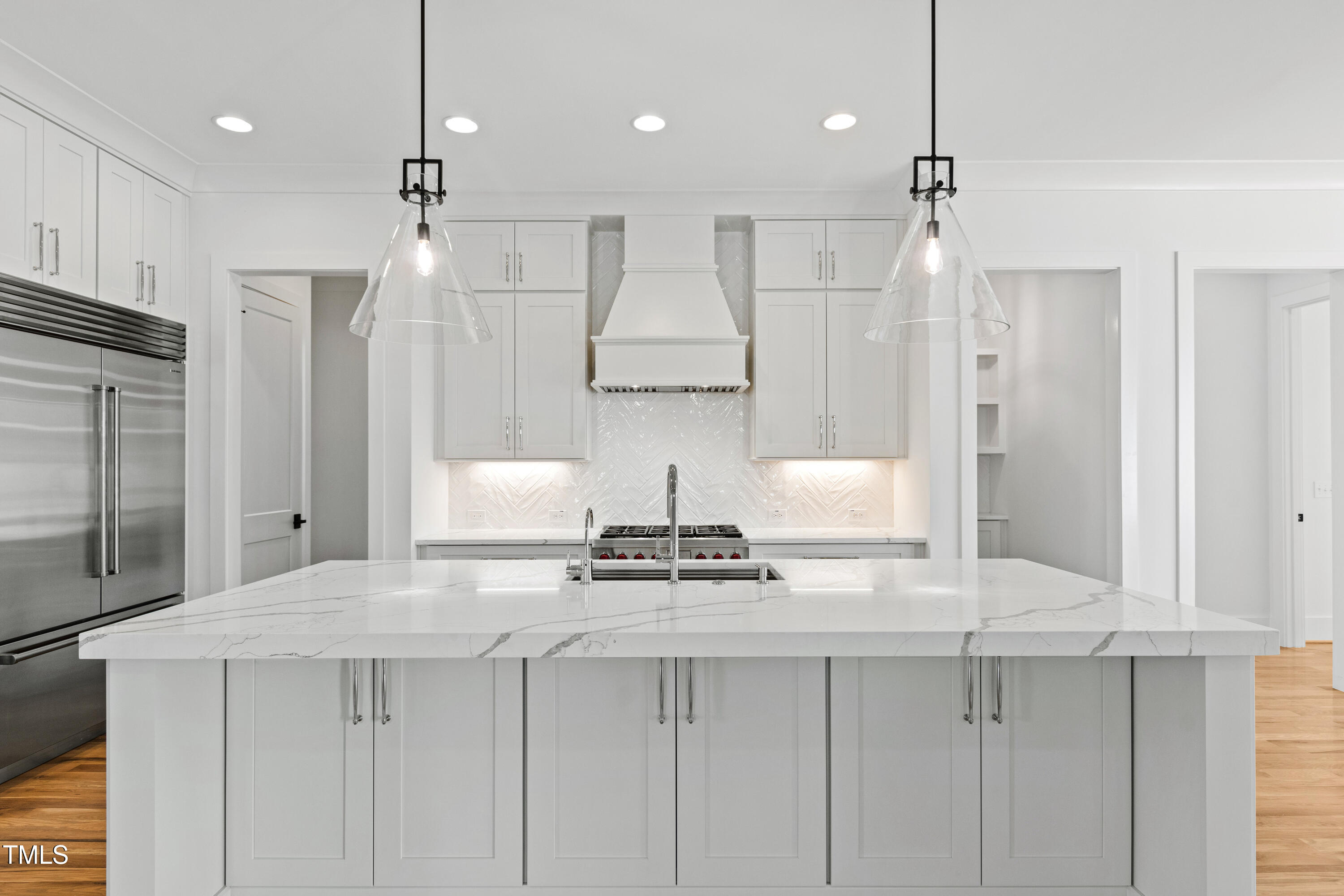 920 Lily Claire Lane Fuquay-Varina, NC 27526 - Photo 11 of 62 a kitchen with kitchen island granite countertop appliances cabinets and a counter top space