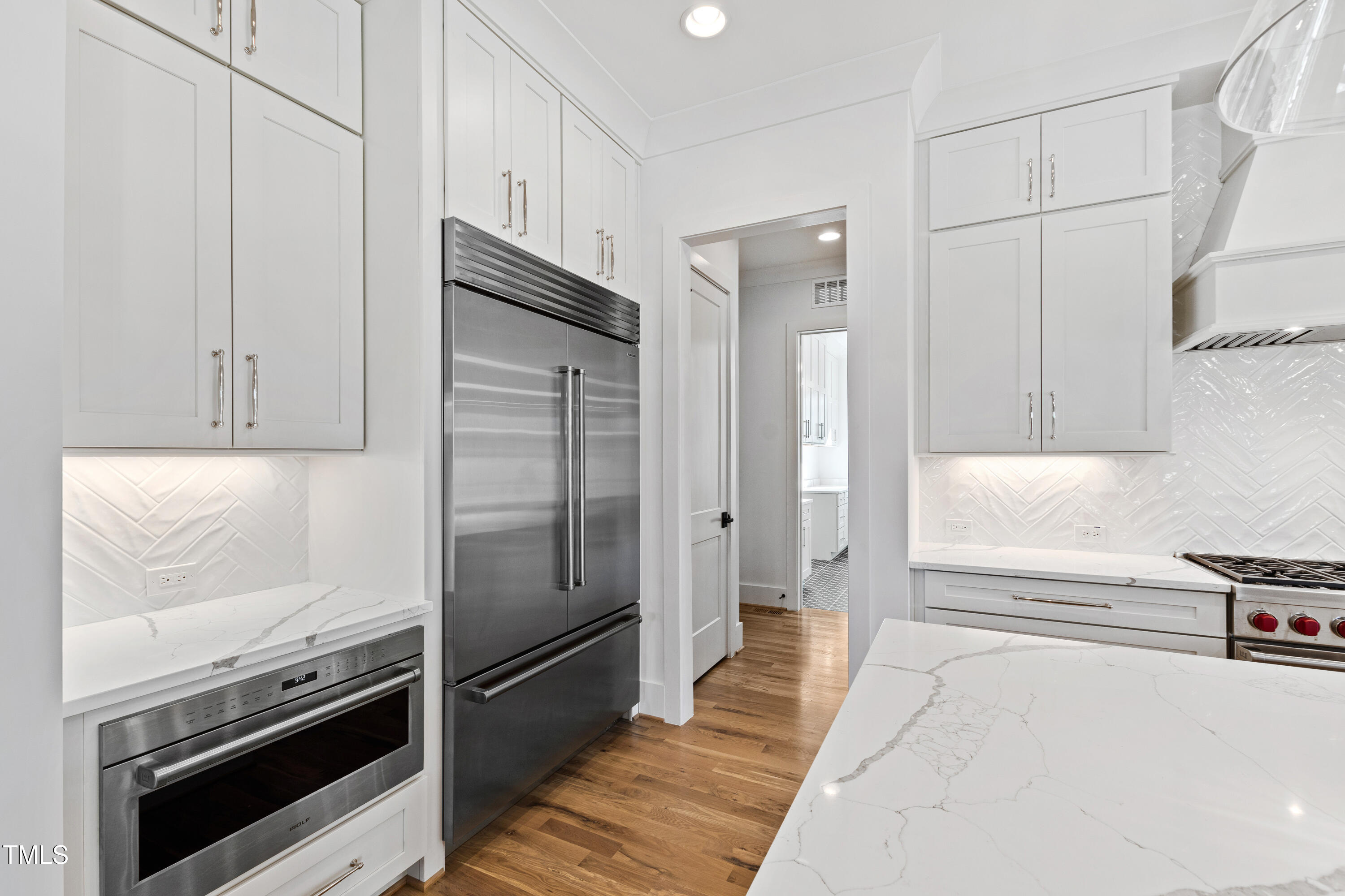 920 Lily Claire Lane Fuquay-Varina, NC 27526 - Photo 12 of 62 a kitchen with stainless steel appliances a refrigerator and a stove