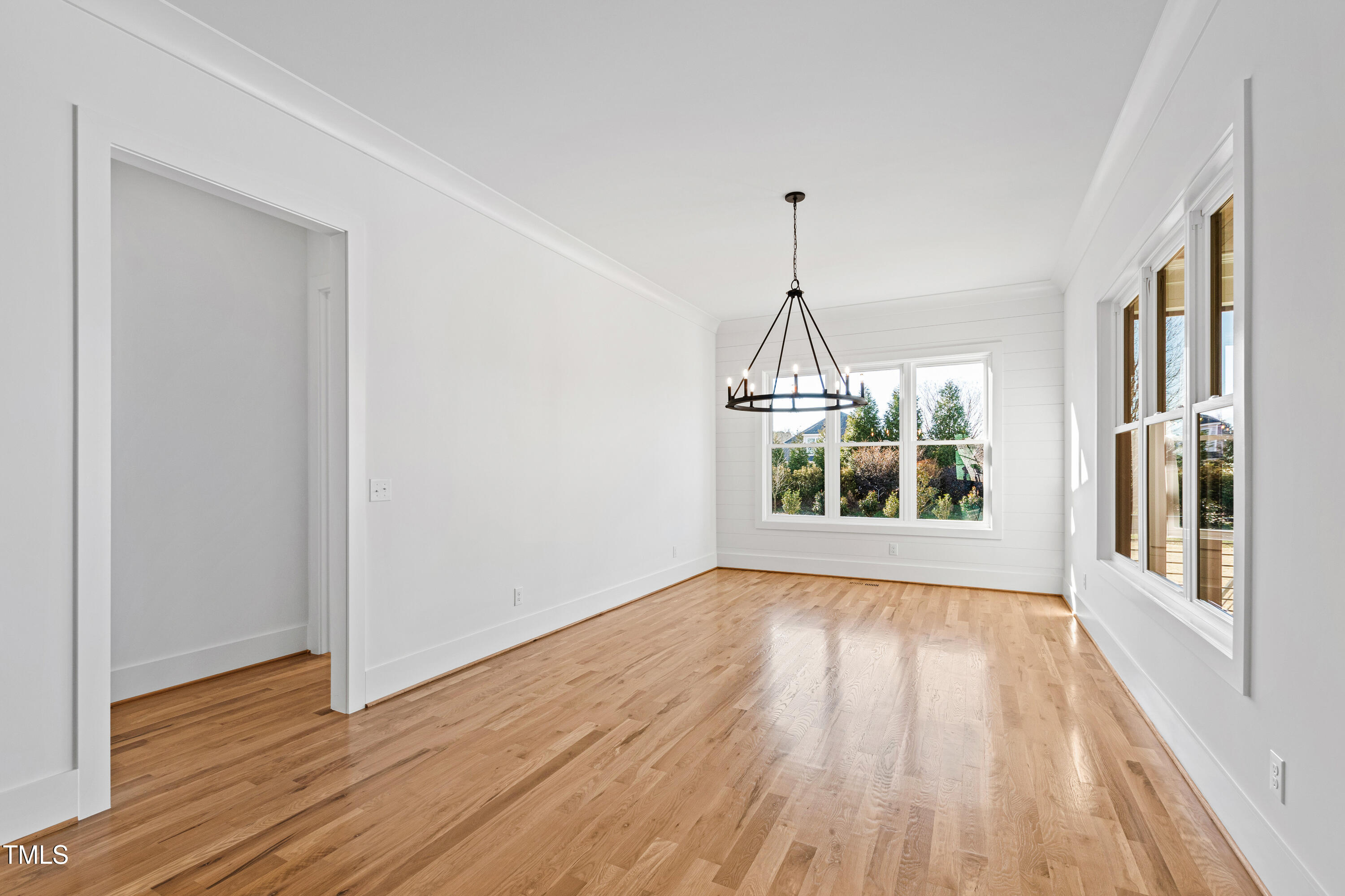 920 Lily Claire Lane Fuquay-Varina, NC 27526 - Photo 15 of 62 a view of an empty room with wooden floor and a window