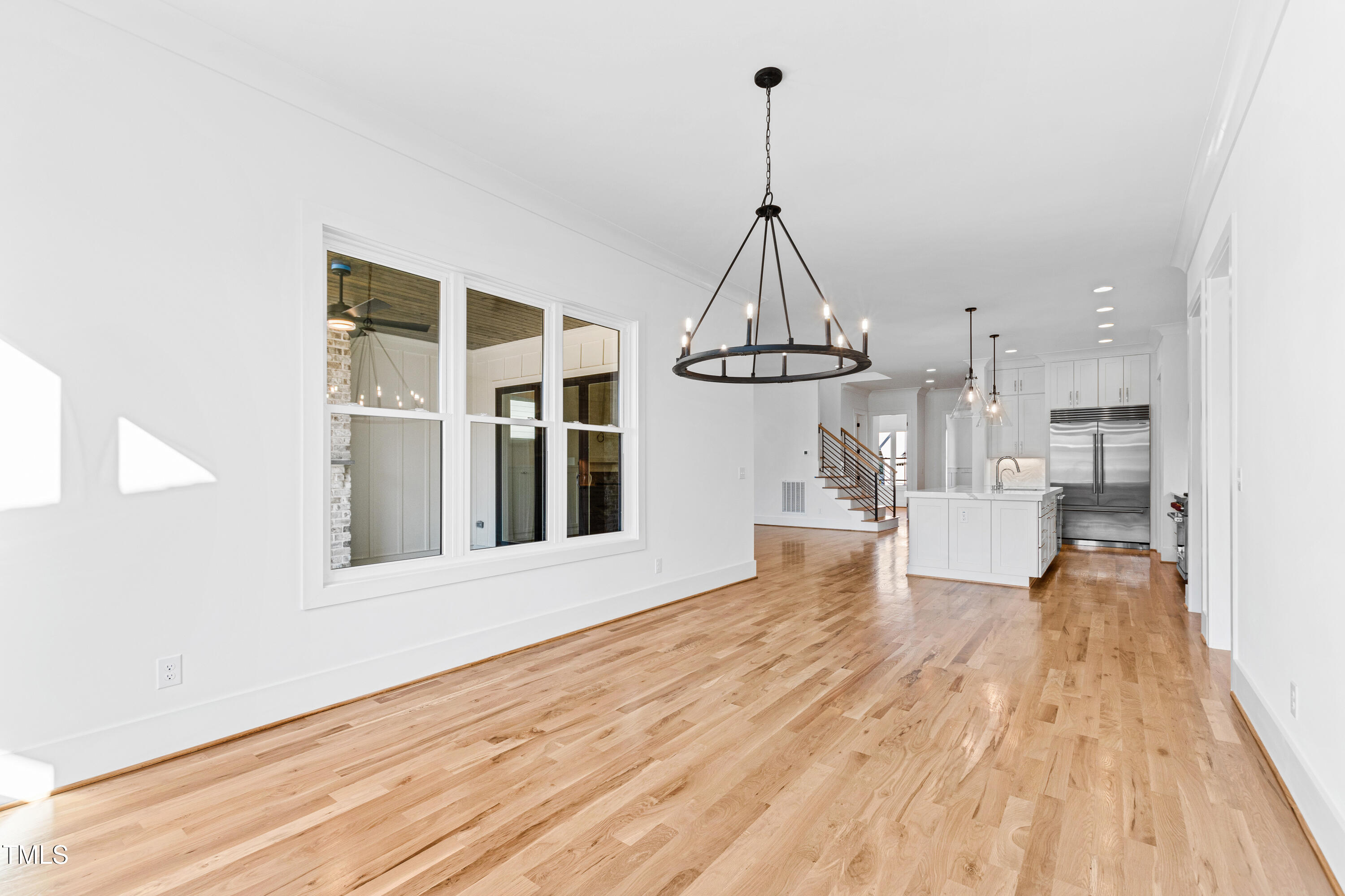 920 Lily Claire Lane Fuquay-Varina, NC 27526 - Photo 17 of 62 a view of empty room with wooden floor and windows