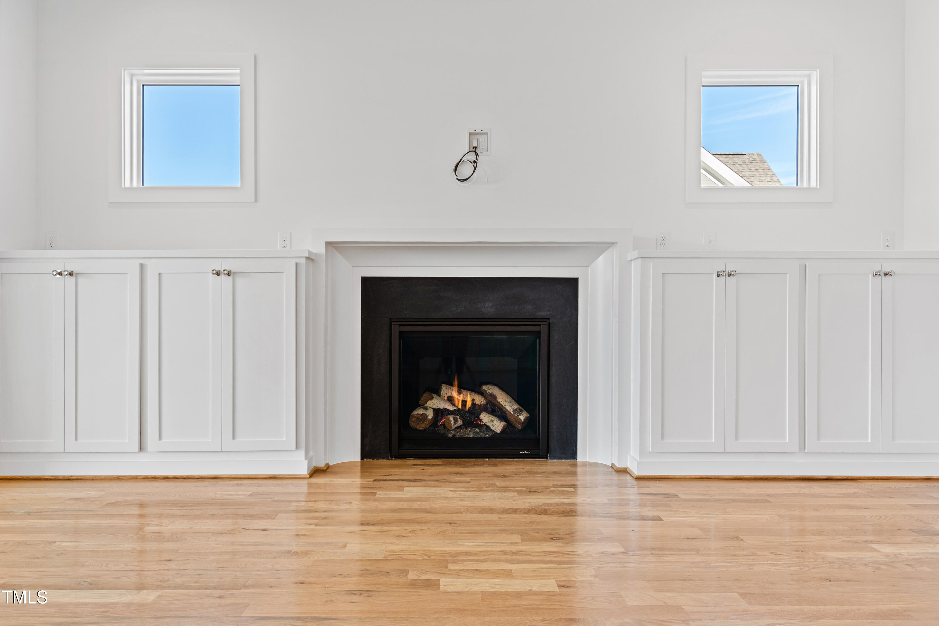920 Lily Claire Lane Fuquay-Varina, NC 27526 - Photo 20 of 62 a view of an empty room with wooden floor and a fireplace