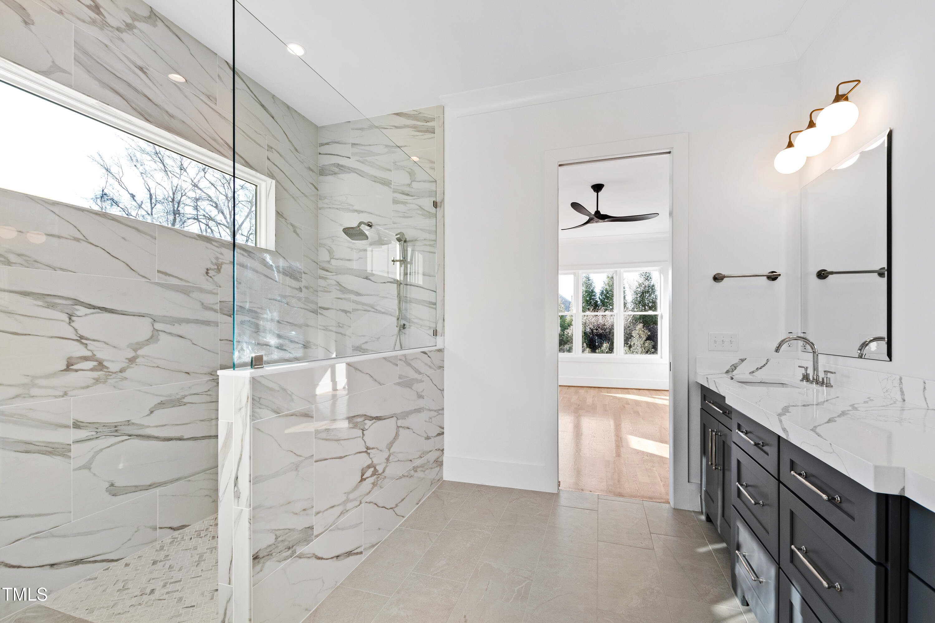 920 Lily Claire Lane Fuquay-Varina, NC 27526 - Photo 24 of 62 a bathroom with a granite countertop sink a mirror and shower