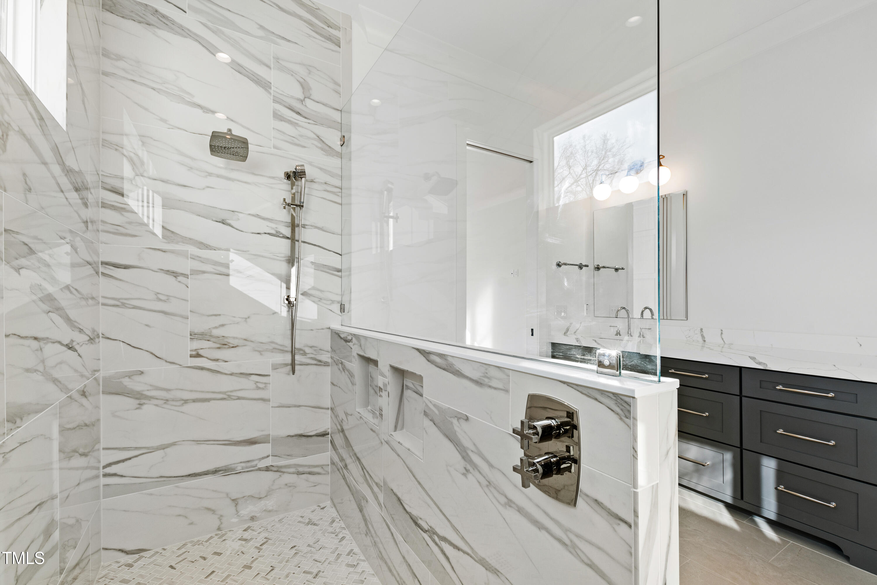 920 Lily Claire Lane Fuquay-Varina, NC 27526 - Photo 26 of 62 a bathroom with a sink a mirror and shower