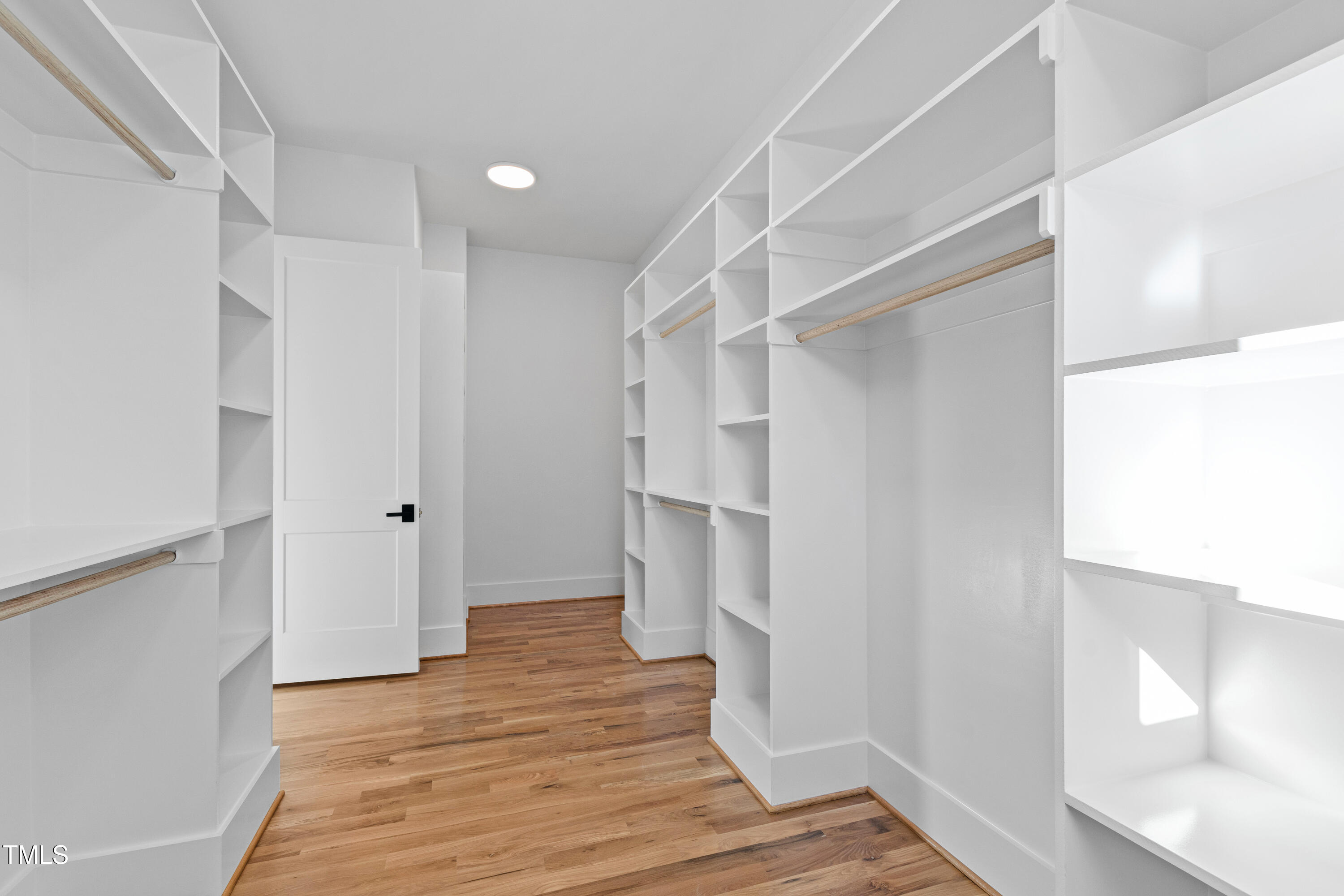 920 Lily Claire Lane Fuquay-Varina, NC 27526 - Photo 28 of 62 a view of walk in closet with wooden floor